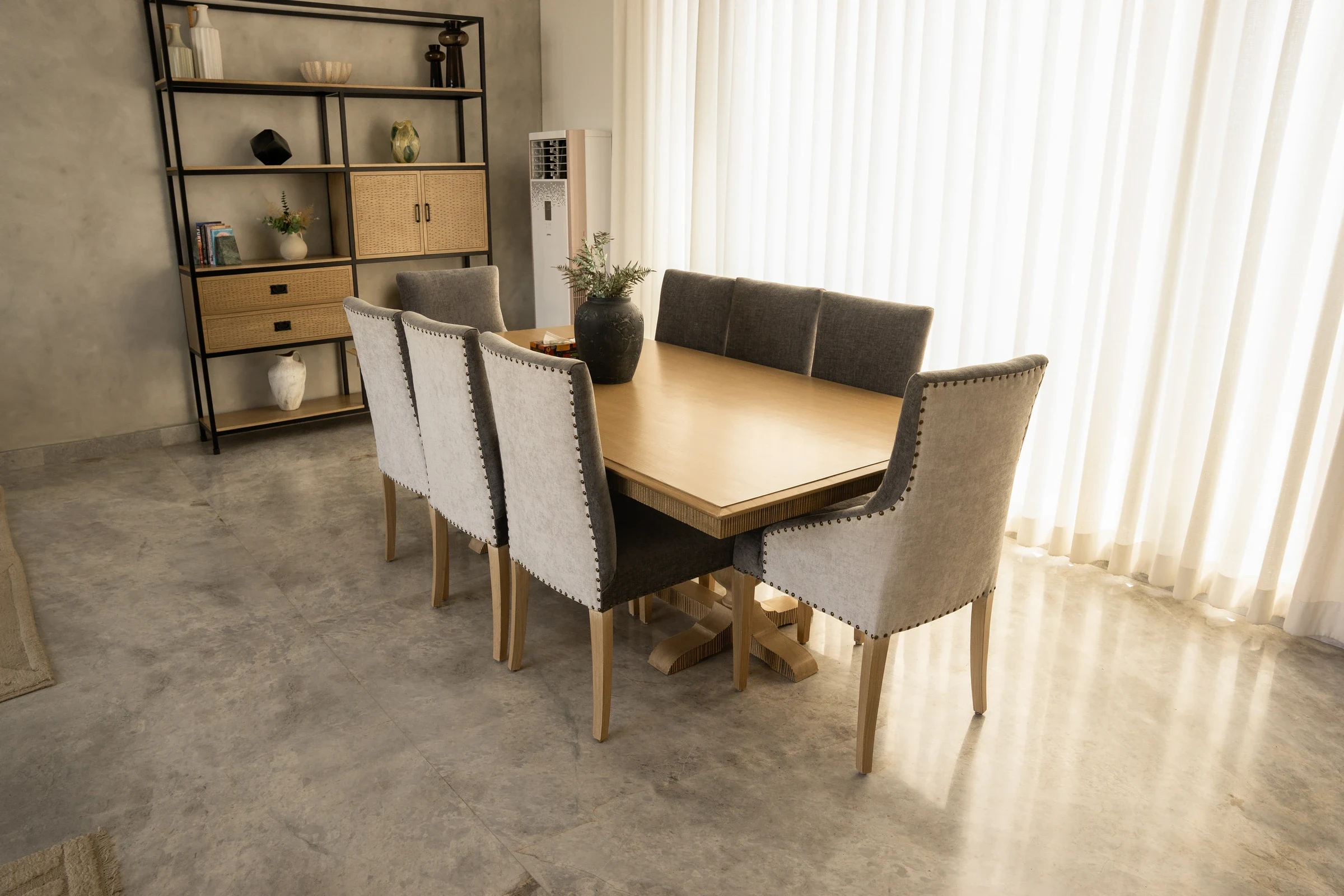 Dining furniture in relation to the room and shelving.