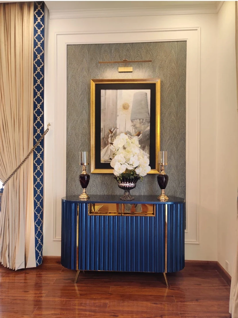 Blue cabinet with mirror and styled accessories.