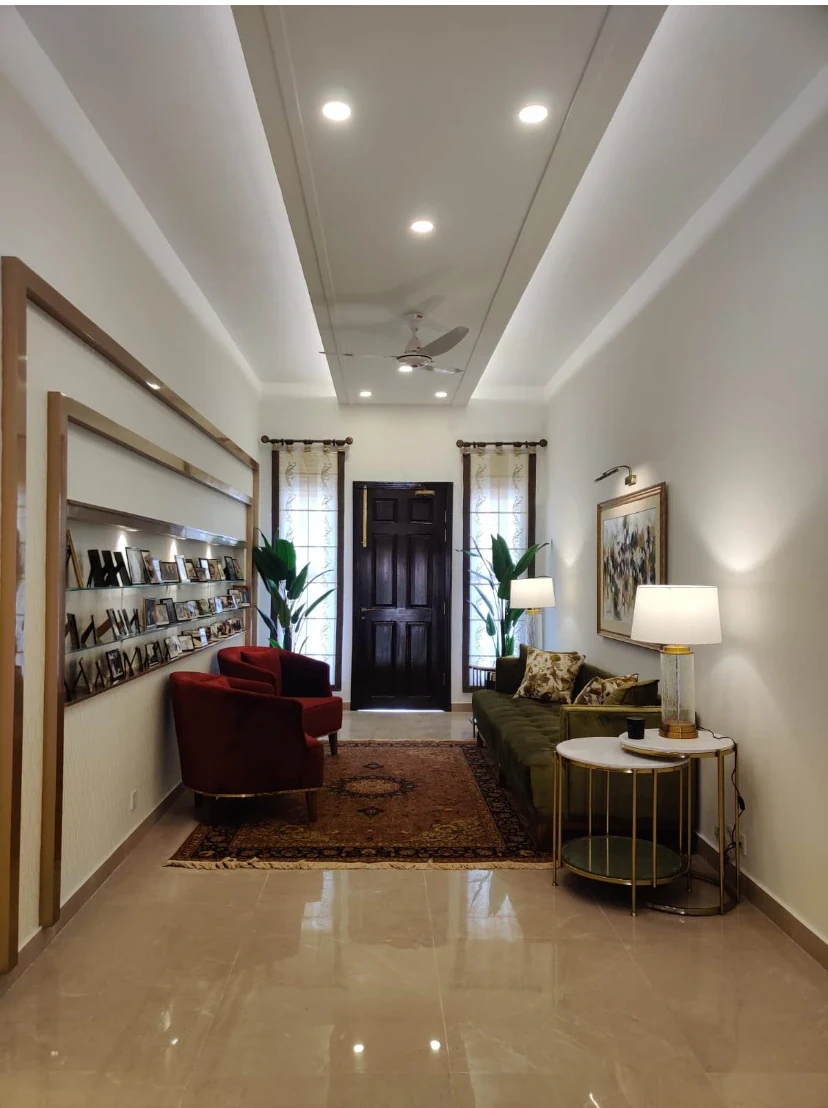 Seating and shelving within a long interior space.