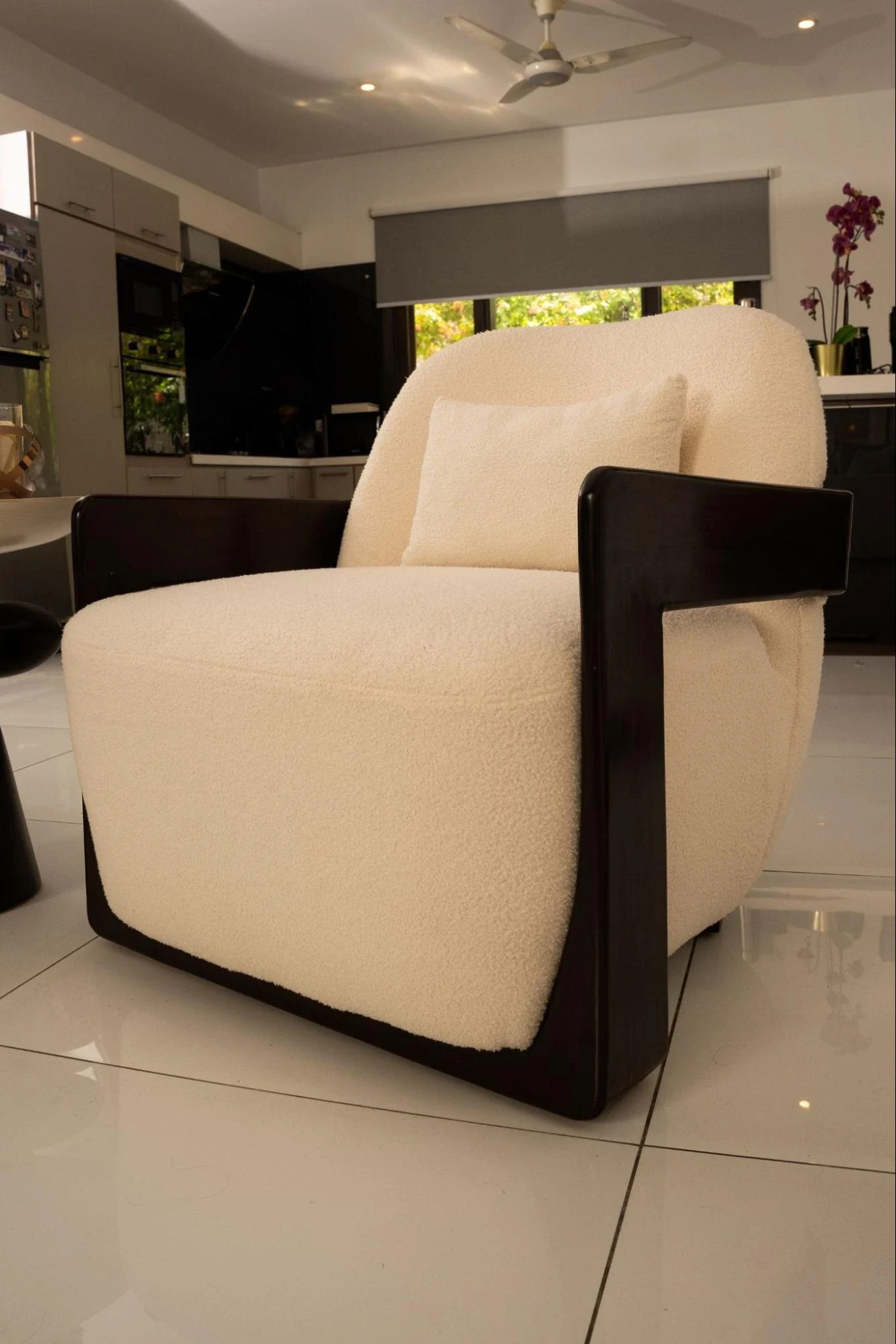 Individual chair with a dark timber frame.