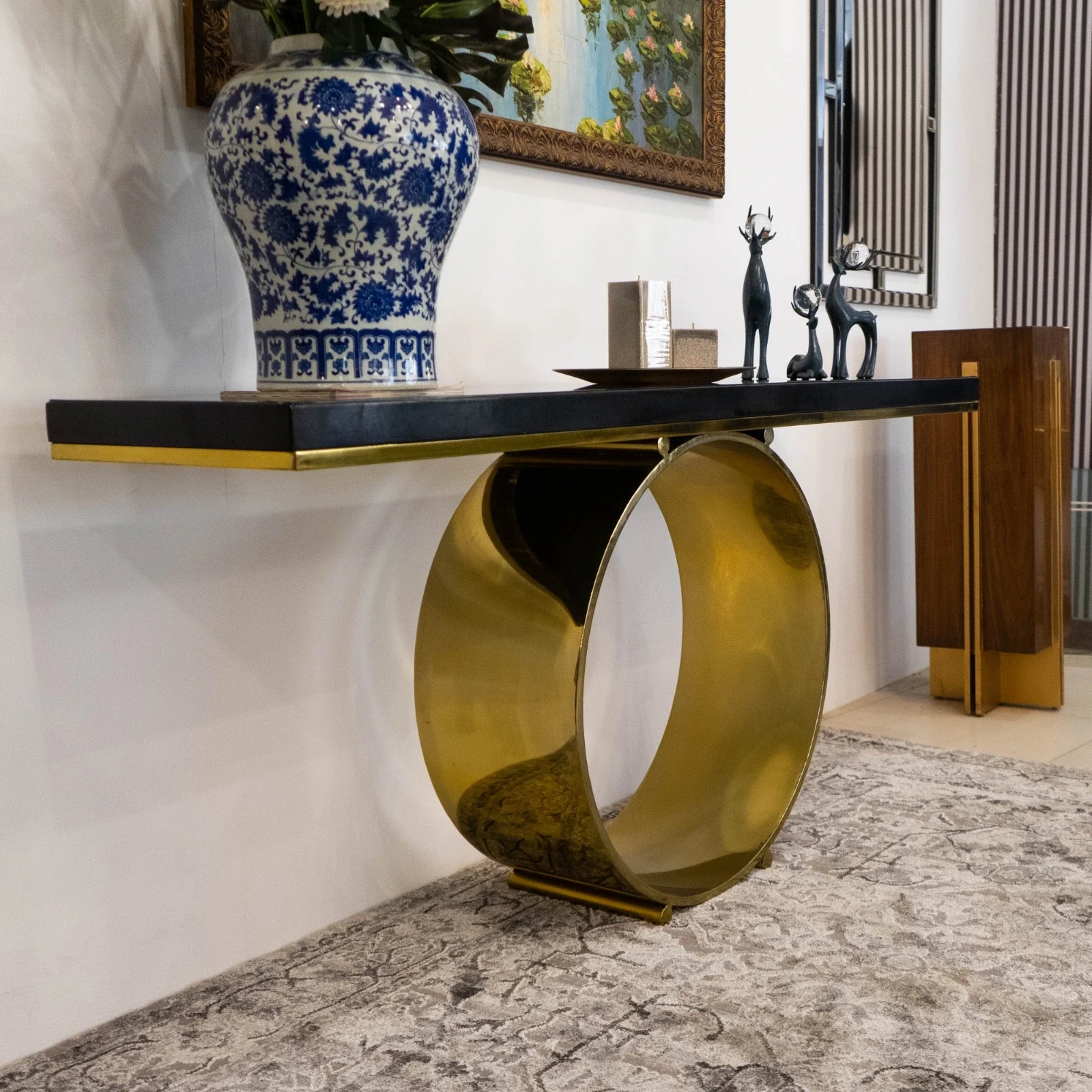Console table with a curved gold base.