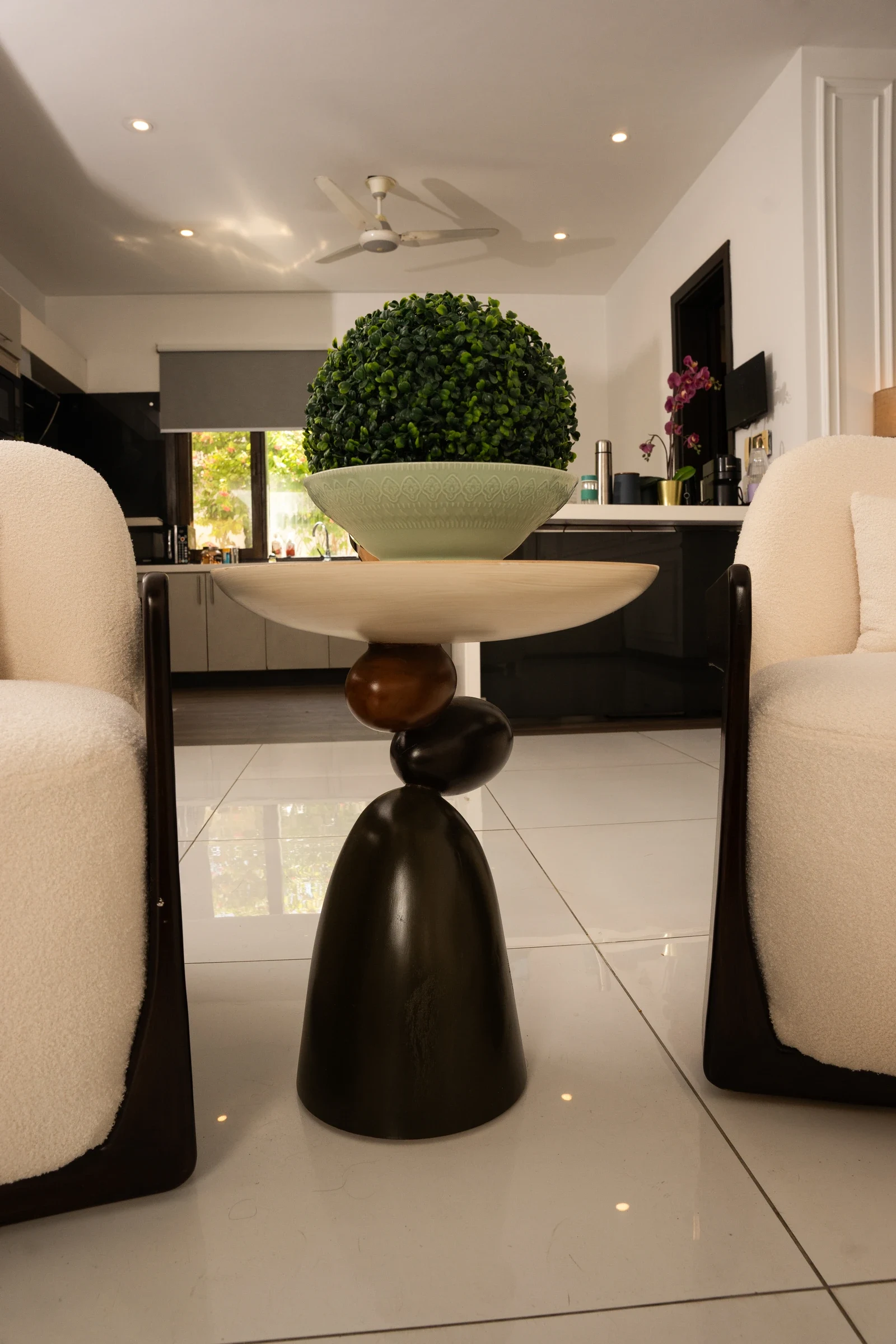 Side table detail between upholstered chairs.