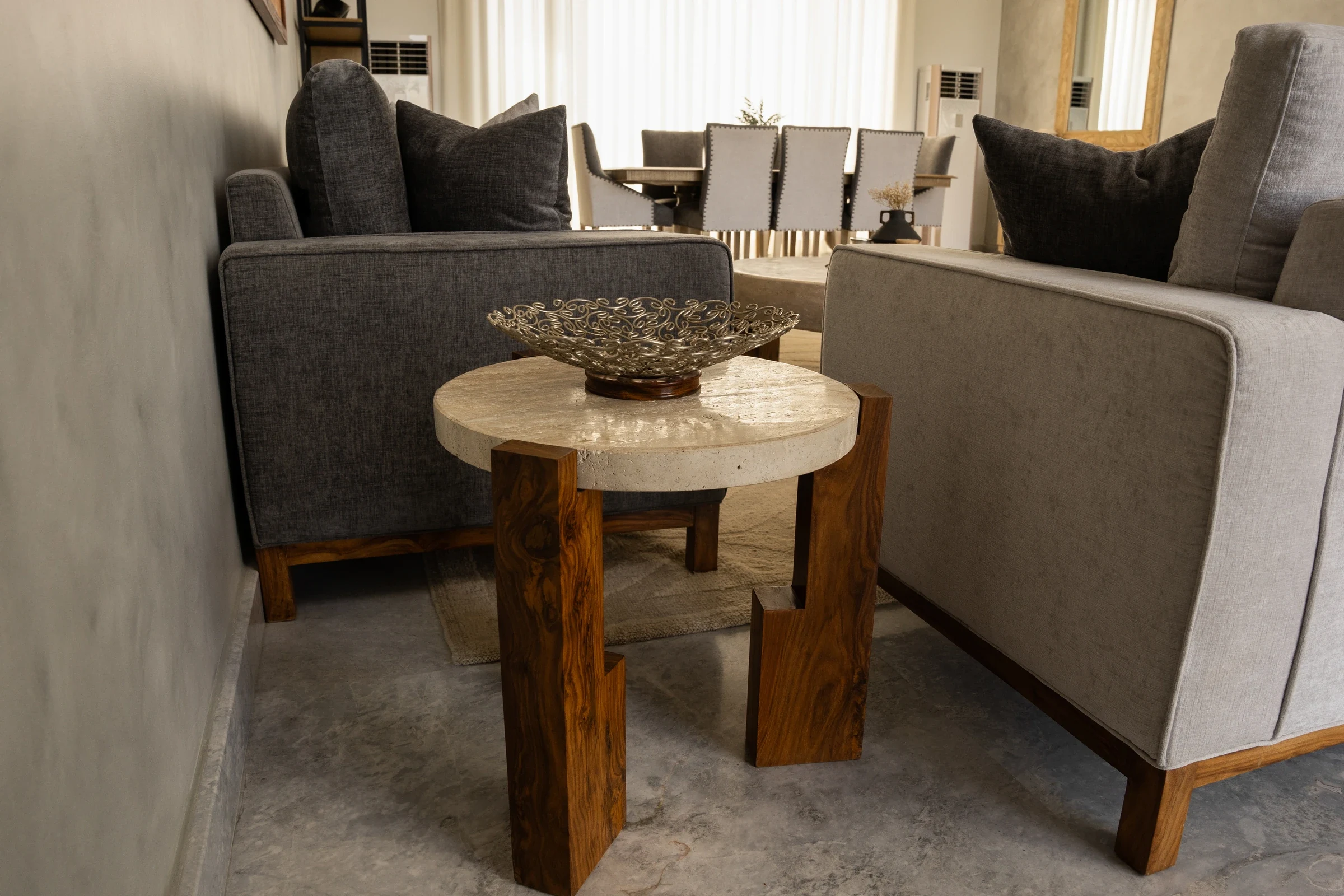 Side table beside grey upholstered seating.