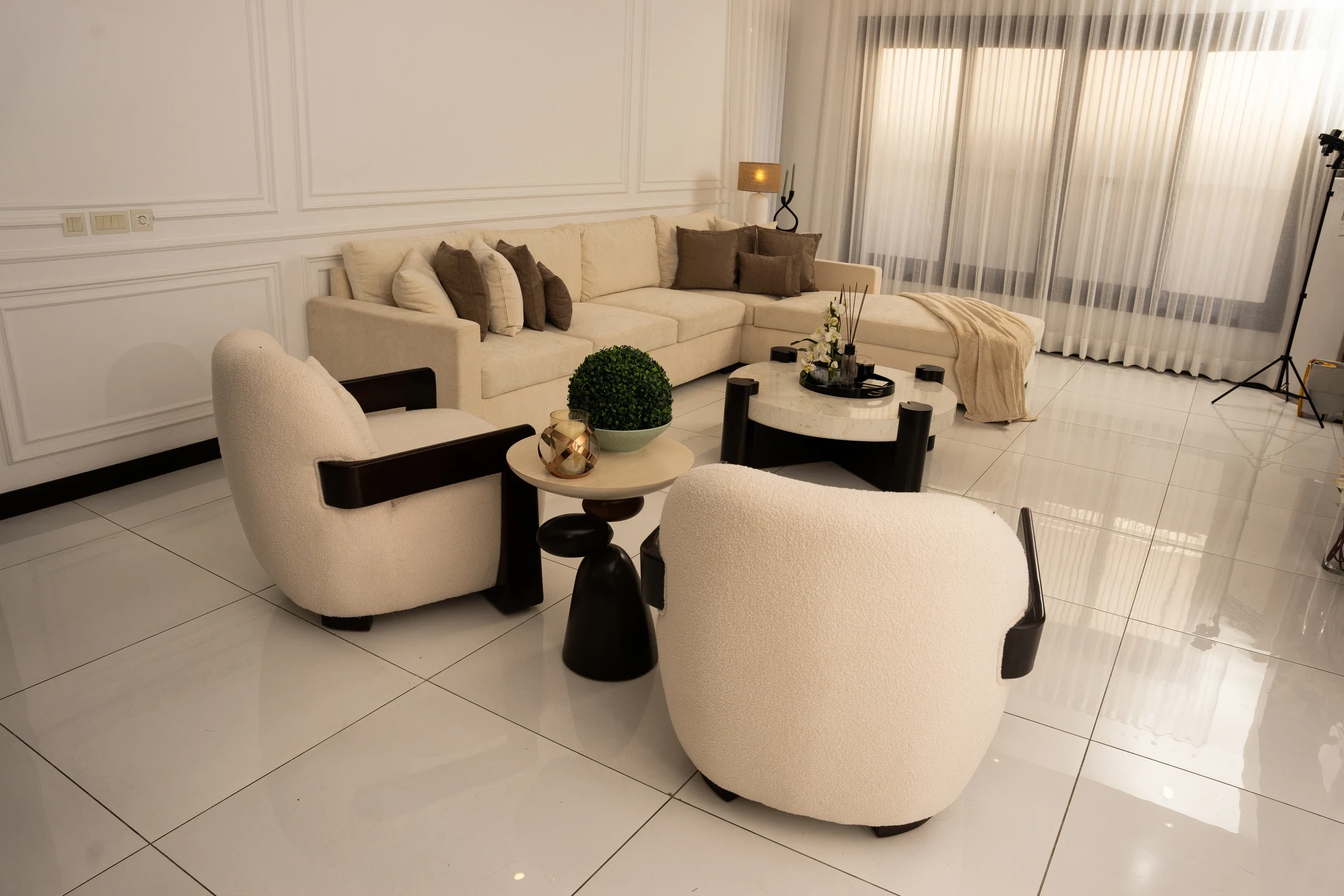 Whole seating arrangement with sectional and curved chairs.